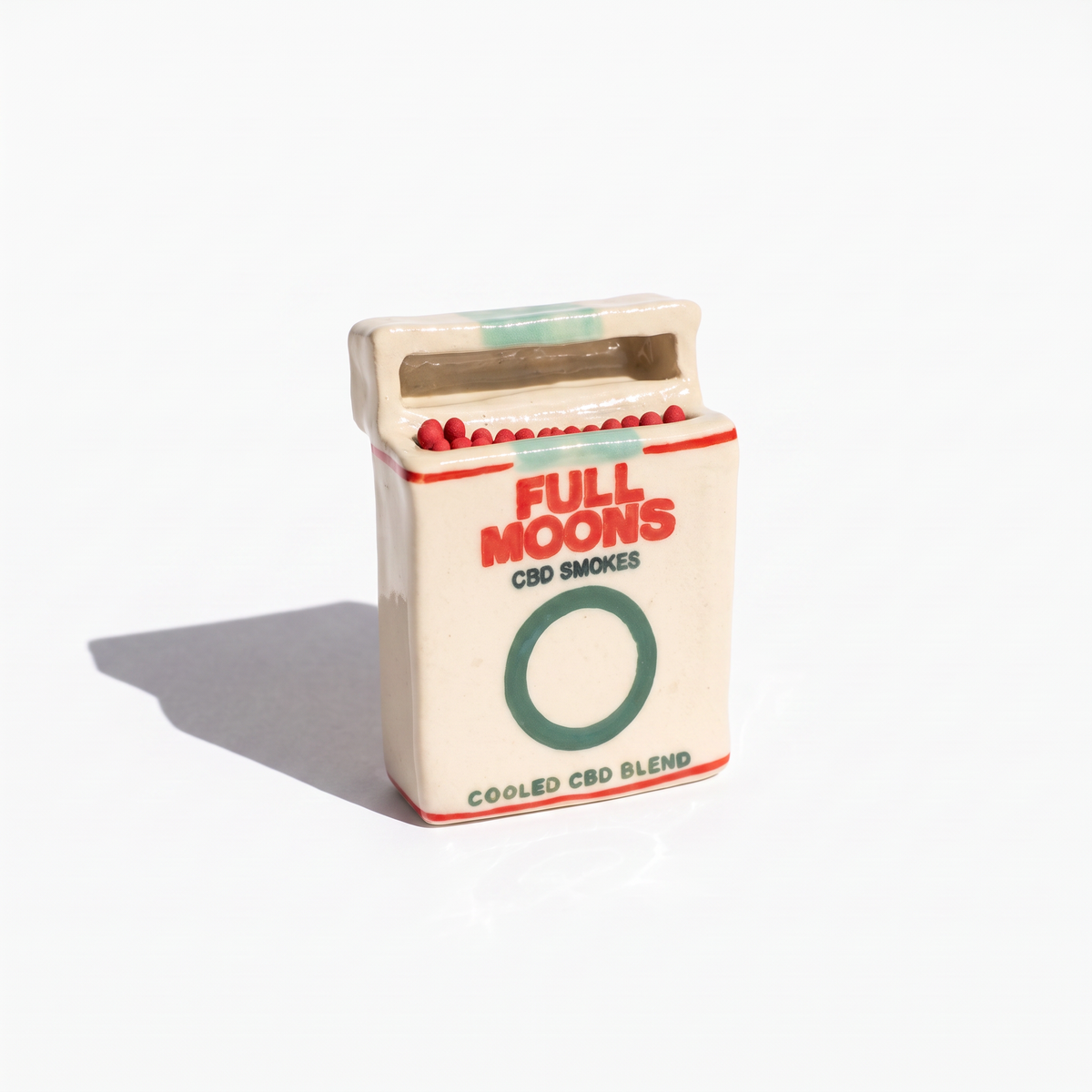 The Memento ceramic matchbox in Cooled, green ring, standing upright with matches