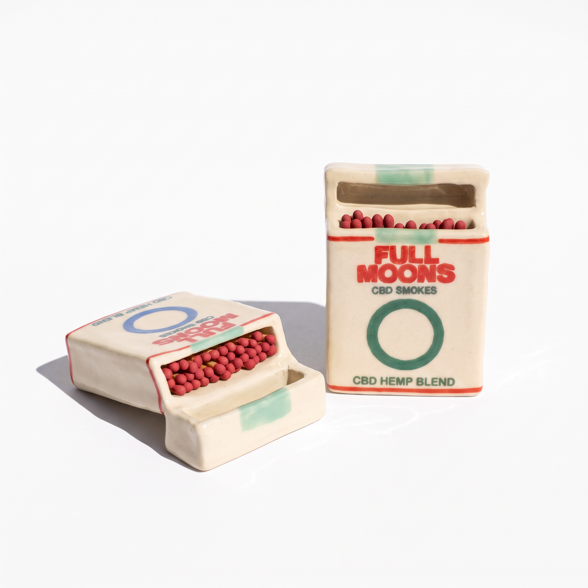 Full Moons Memento ceramic matchboxes in Original and Cooled, filled with red-tipped matches