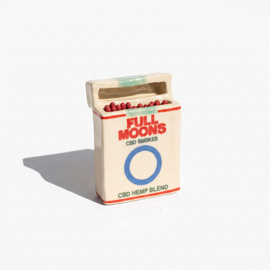 The Memento ceramic matchbox in Original, blue ring, standing upright with matches